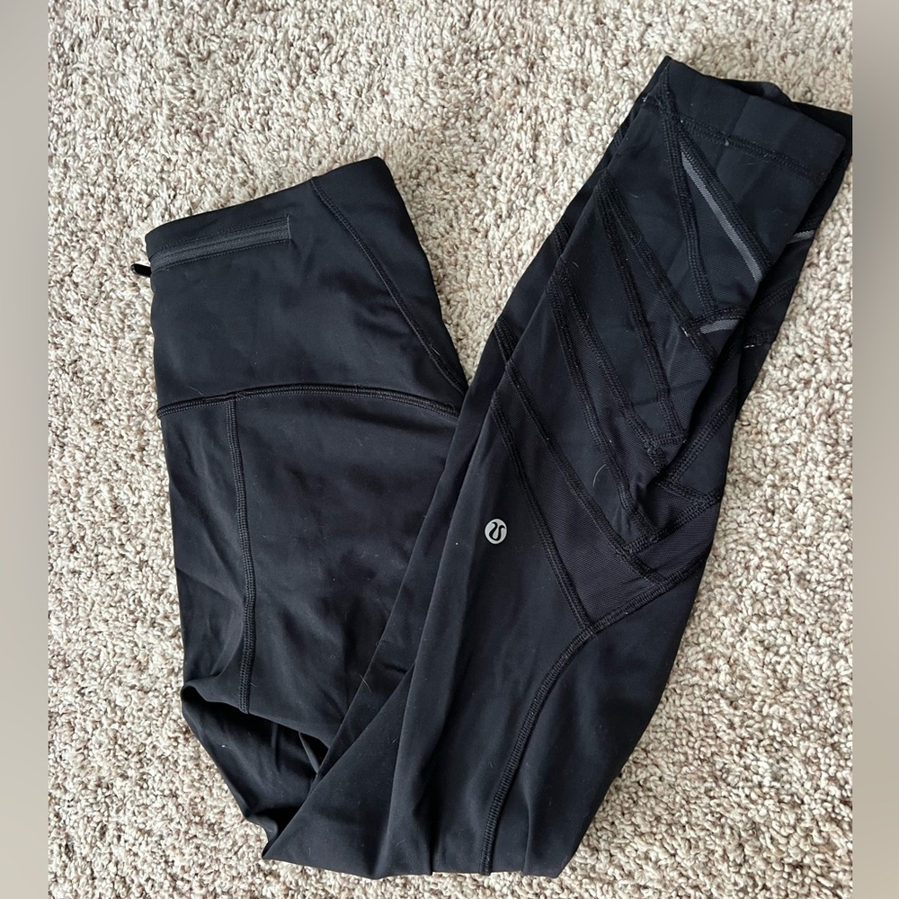 Lululemon- well loved- high rise with mesh design at bottom- size 6- black